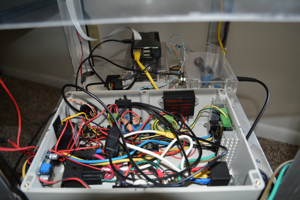 Power box contains Sabertooth 2x32 controller, terminal blocks, 24v-to-12v DC-DC converter, 12v-to-5v DC-DC converter, relays, and USB power supply.