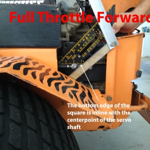 The bottom edge of the square is inline with the centerpoint of the servo shaft. Notice that at full throttle forward the servo stays safely below this line.